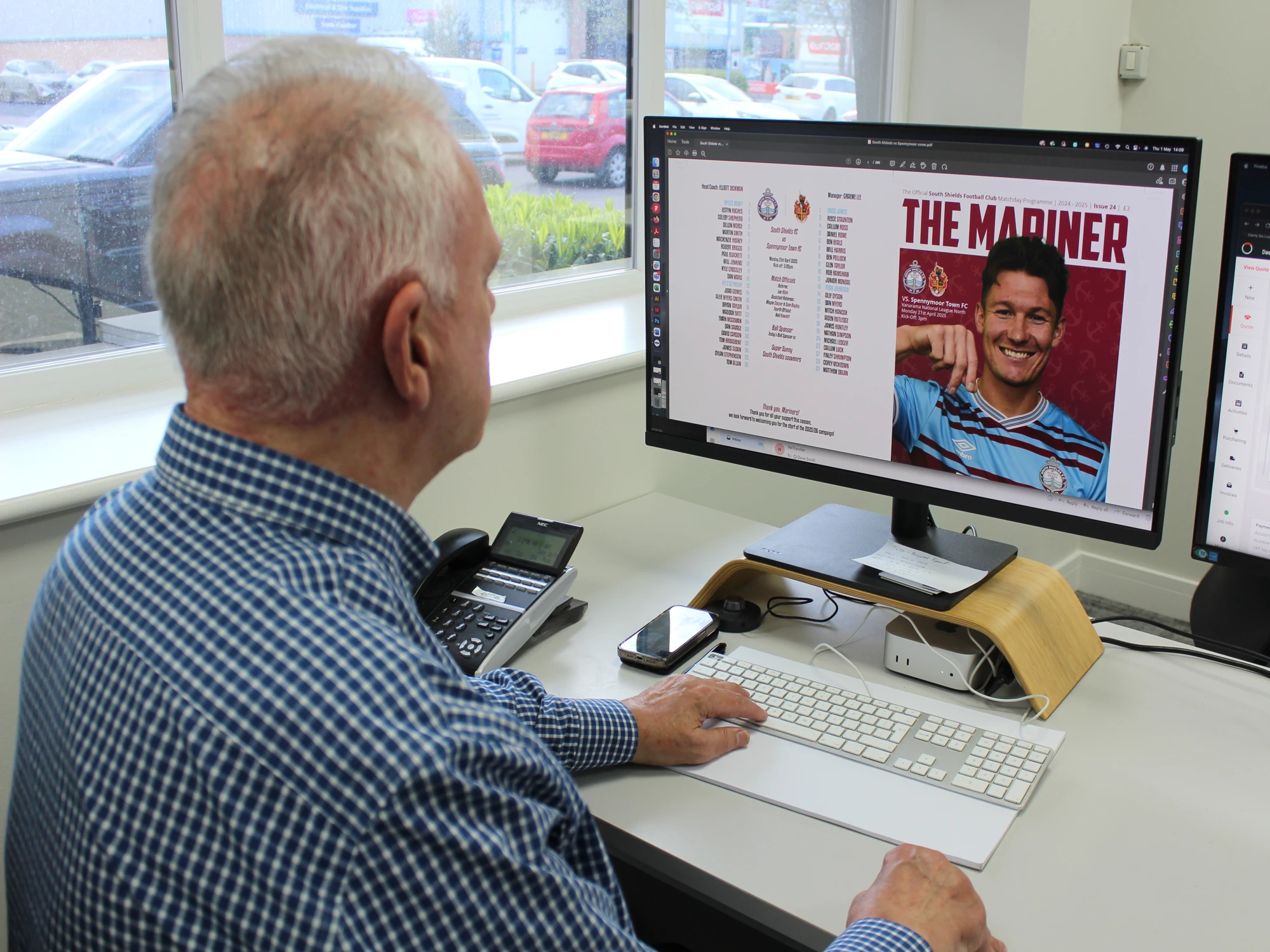 TVP Print Manager Dave Smith looking at the design for The Mariner match programme on his monitor. 